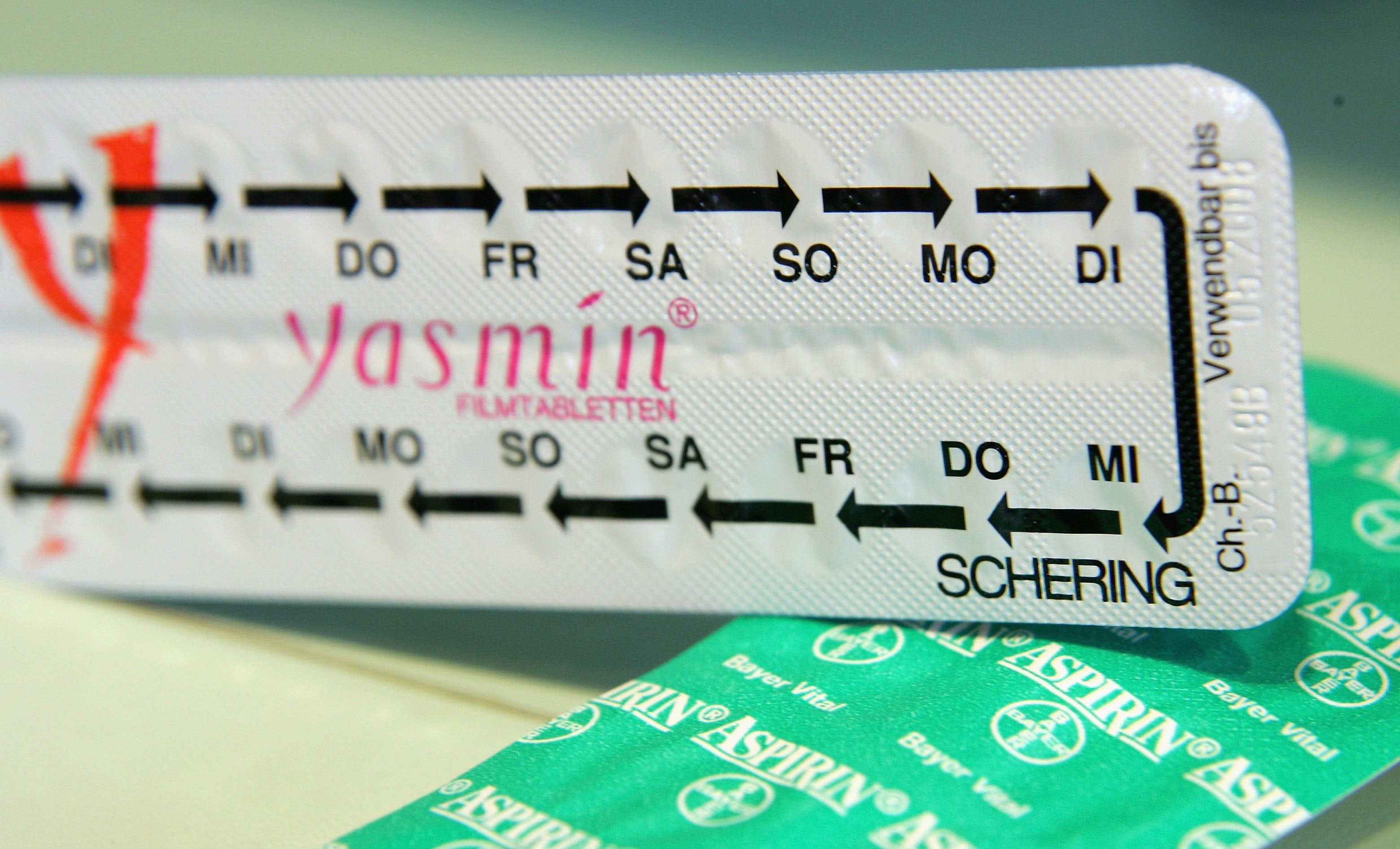 Packages of Bayer aspirin and Schering Yasmin contraceptive pills lie on a table at a pharmacy on 24 March, 2006 in Berlin, Germany. Concerns have been raised around why birth control pills are not safer, given the risk of blood clotting and other side effects.