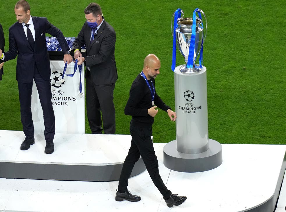 <p>Manchester City boss Pep Guardiola walks past the European Cup after his side were beaten 1-0 by Chelsea in Porto (Adam Davy/PA).</p>