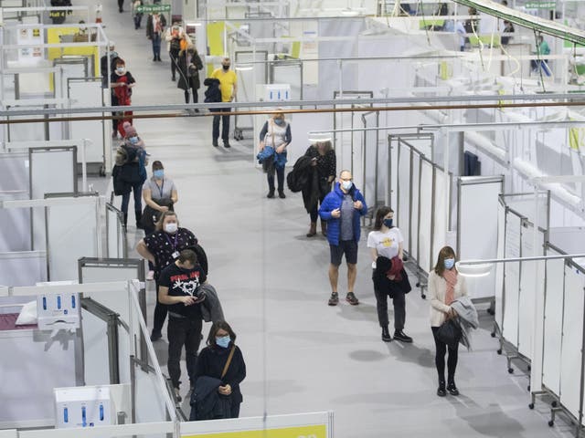 <p>People queue for the Covid vaccine at SSE Hydro in Glasgow</p>