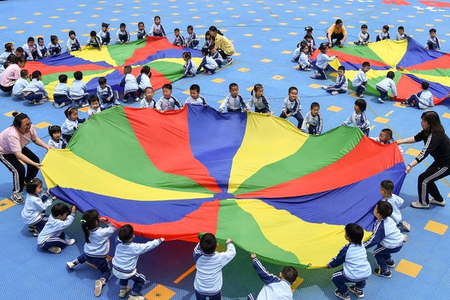 <p>Children play at a kindergarten in Yantai, Shandong, on 31 May 2021</p>