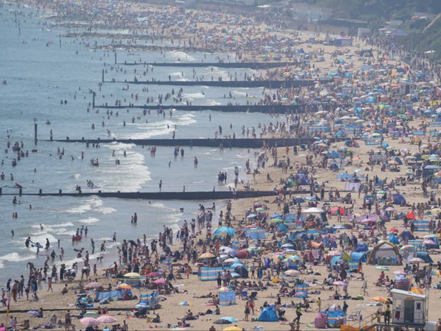<p>People enjoy the hot weather on Bournemouth beach, Dorset</p>