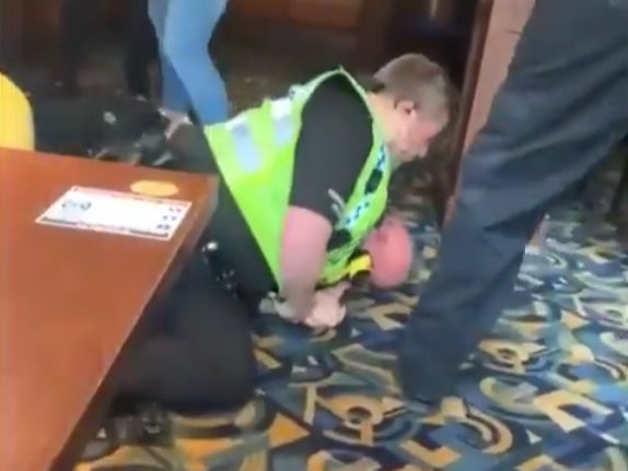 An officer wrestles a man to the ground in the viral video of the incident at the Blue Bell Inn in Scarborough