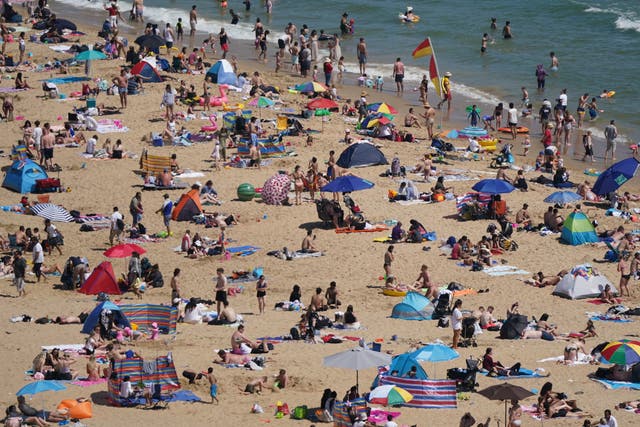 <p>People enjoy the hot weather on Bournemouth beach, Dorset</p>
