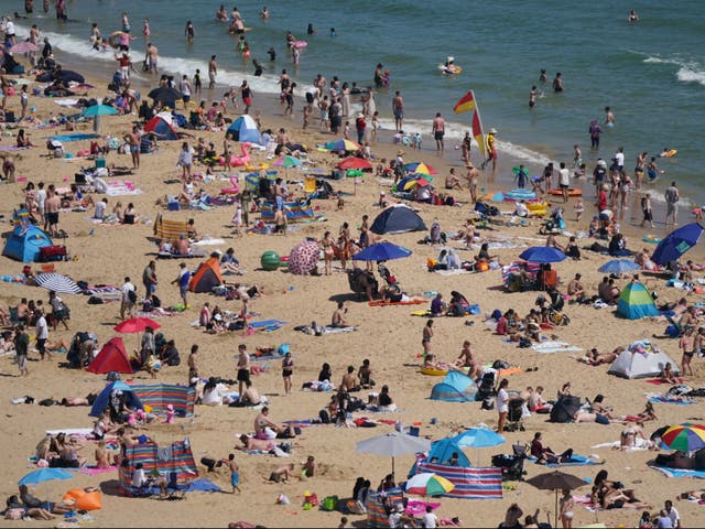 <p>People enjoy the hot weather on Bournemouth beach, Dorset</p>