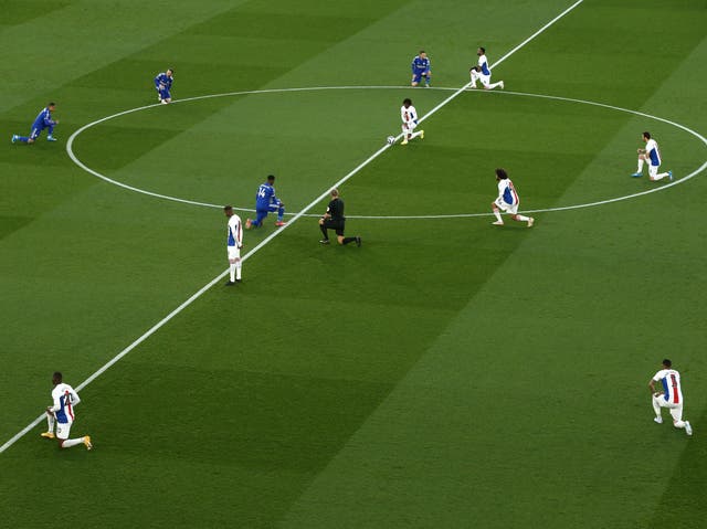 <p>Leicester and Crystal Palace players kneel before kick-off</p>