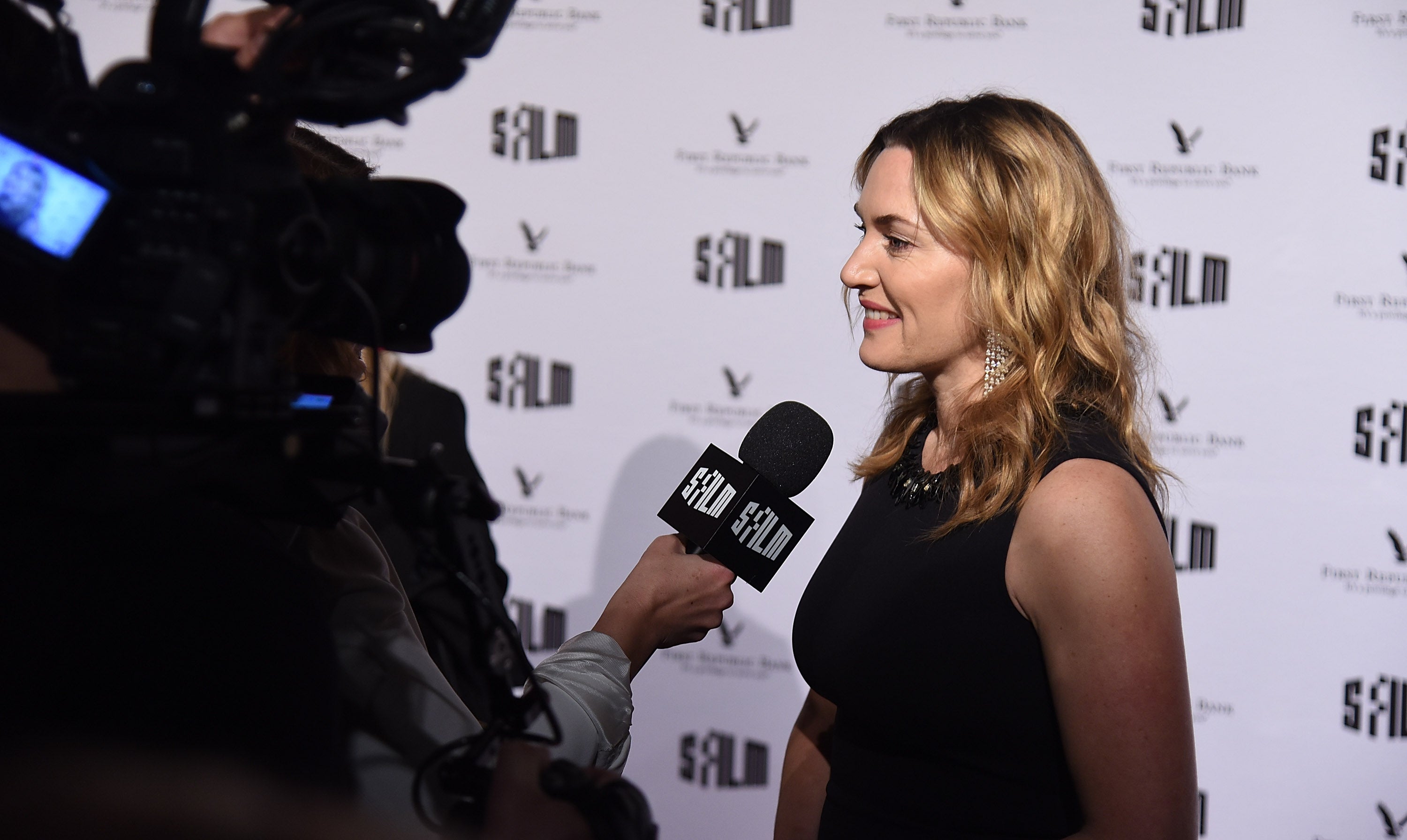 To camera: Winslet faces the press at the Palace of Fine Arts, San Francisco