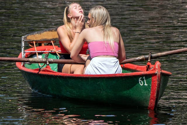 <p>Two woman enjoy the sun aboard a boat on the River Nidd in Knaresborough, North Yorkshire, on the first day of meteorological summer</p>
