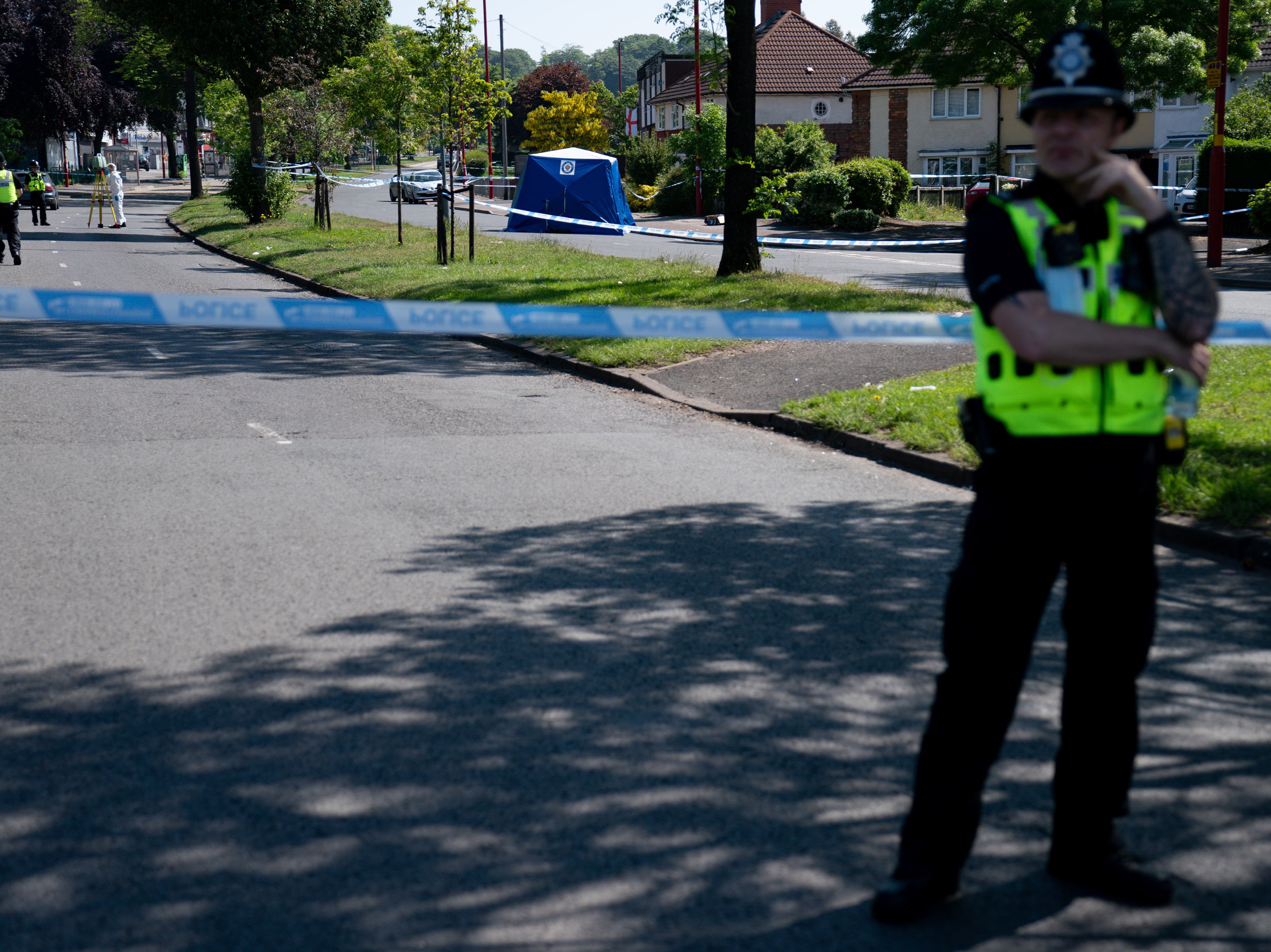 Police officer at the scene on College Road, Kingstanding, on the outskirts of Birmingham