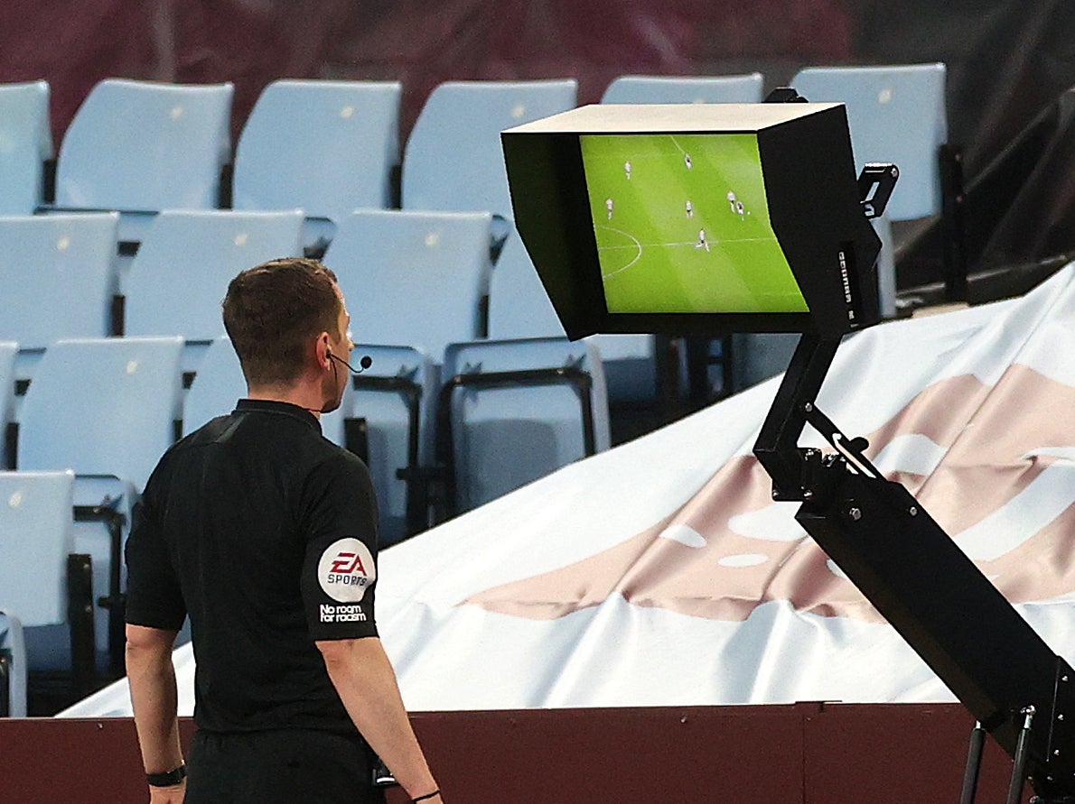 Referee Peter Bankes checks the VAR monitor as Aston Villa take on Manchester City