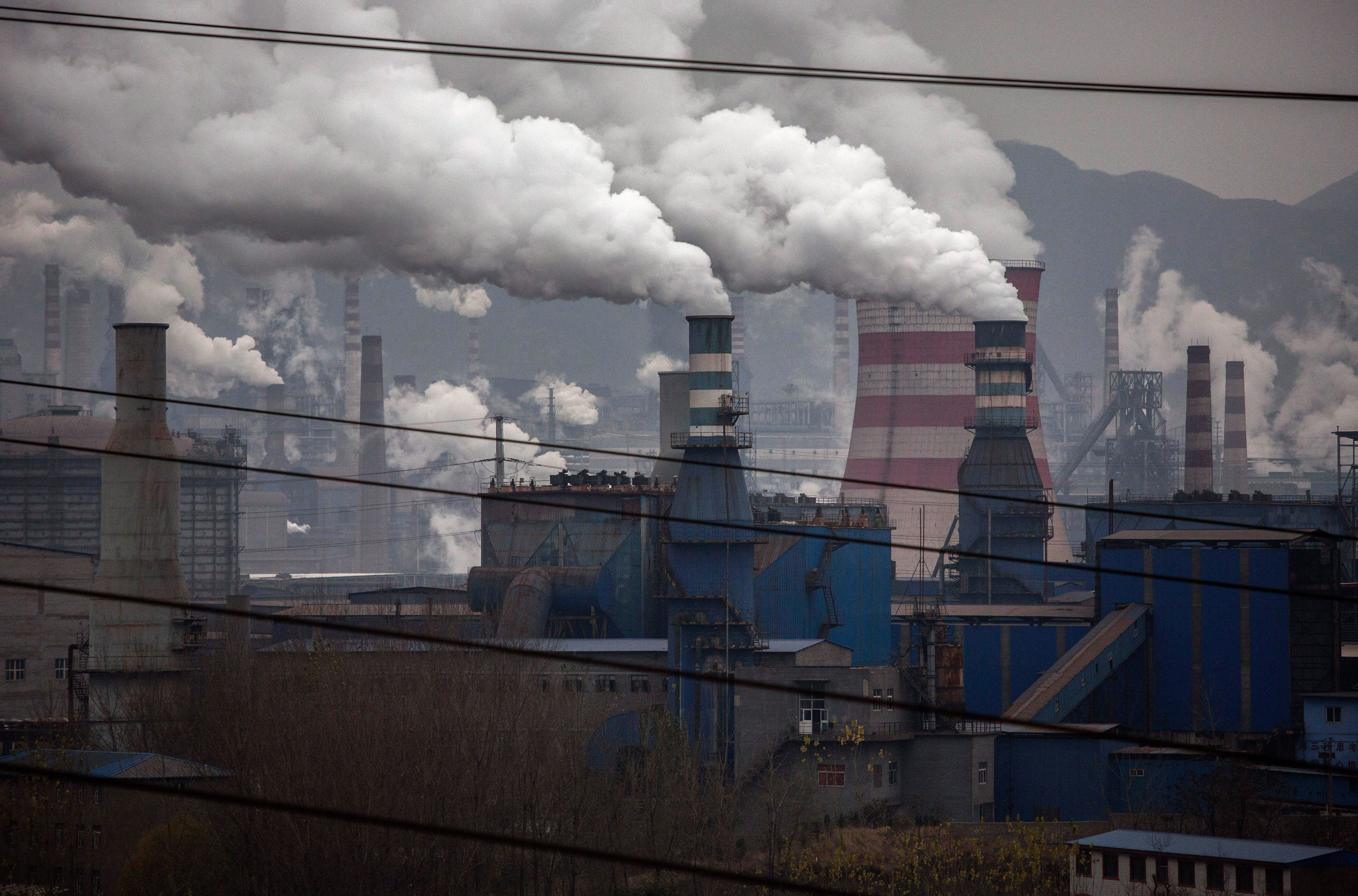 Smoke billows from smokestacks and a coal fired generator at a steel factory in the industrial province of Hebei, China.