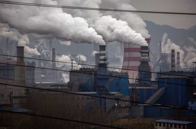<p>Smoke billows from smokestacks and a coal fired generator at a steel factory in the industrial province of Hebei, China.</p>