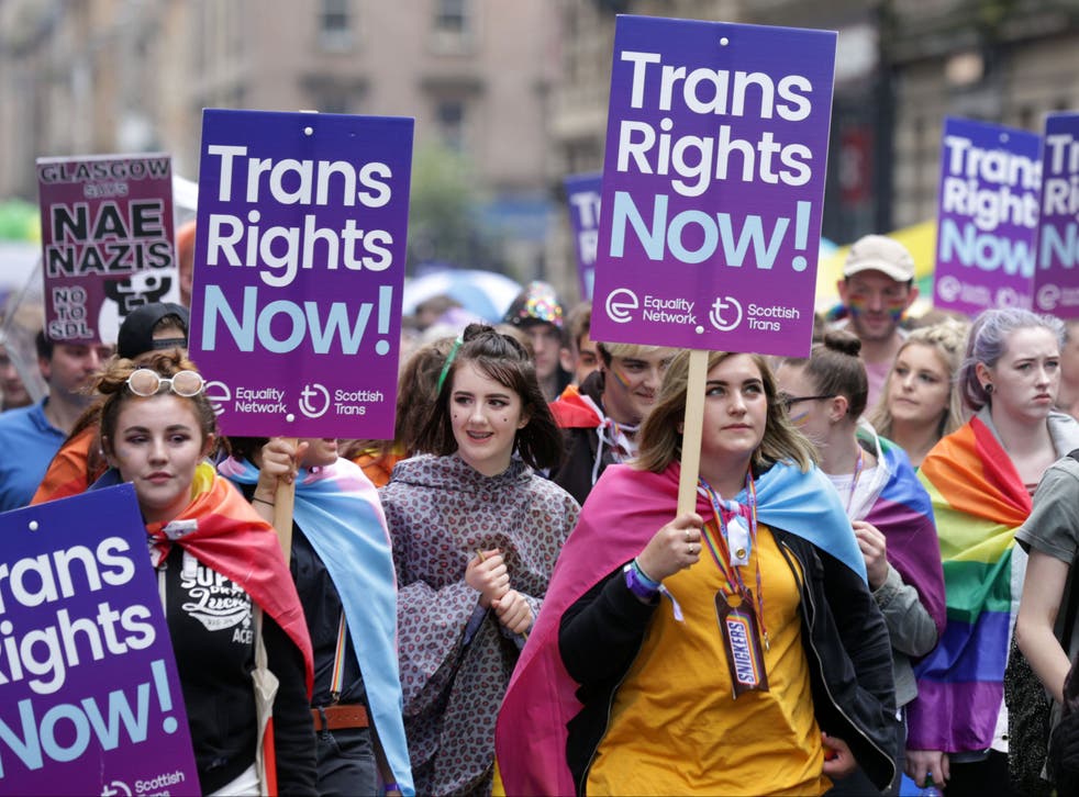 <p>People carrying trans rights banners take part in the Pride Glasgow parade</p>