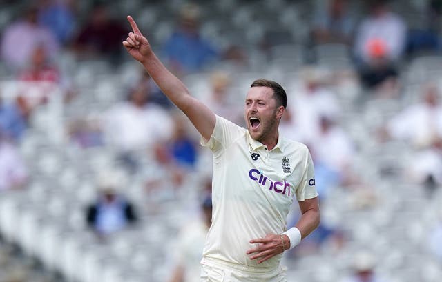 <p>Ollie Robinson celebrates a wicket</p>