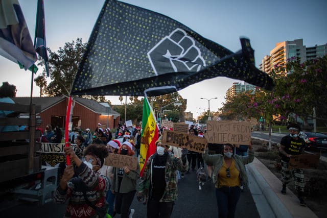 <p>Protesters march through the Marina Del Rey neighbourhood of Los Angeles during a Black Lives Matter rally to demand social justice on December 19, 2020</p>