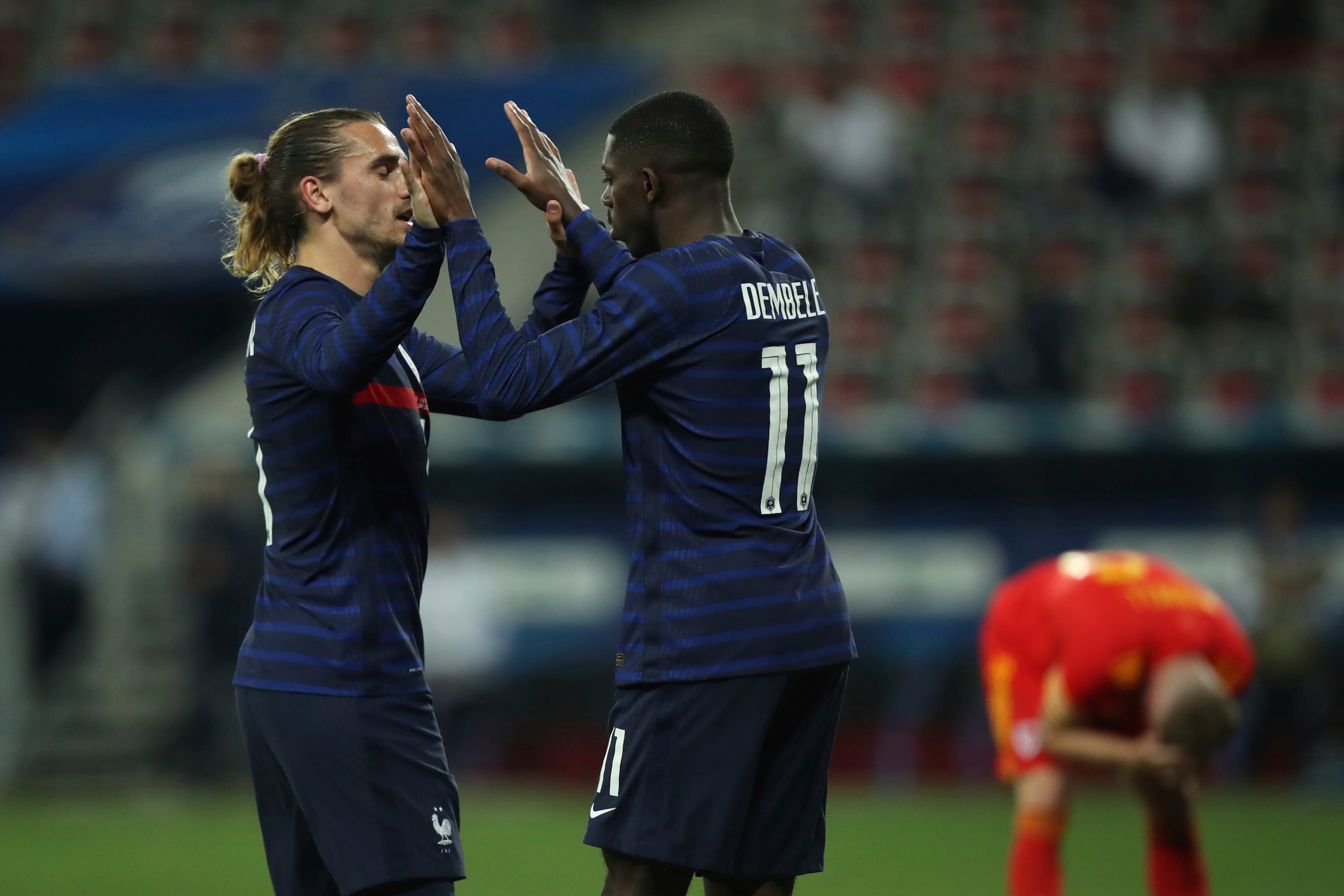 Ousmane Dembele celebrates with France’s Antoine Griezmann after scoring his side’s third goal