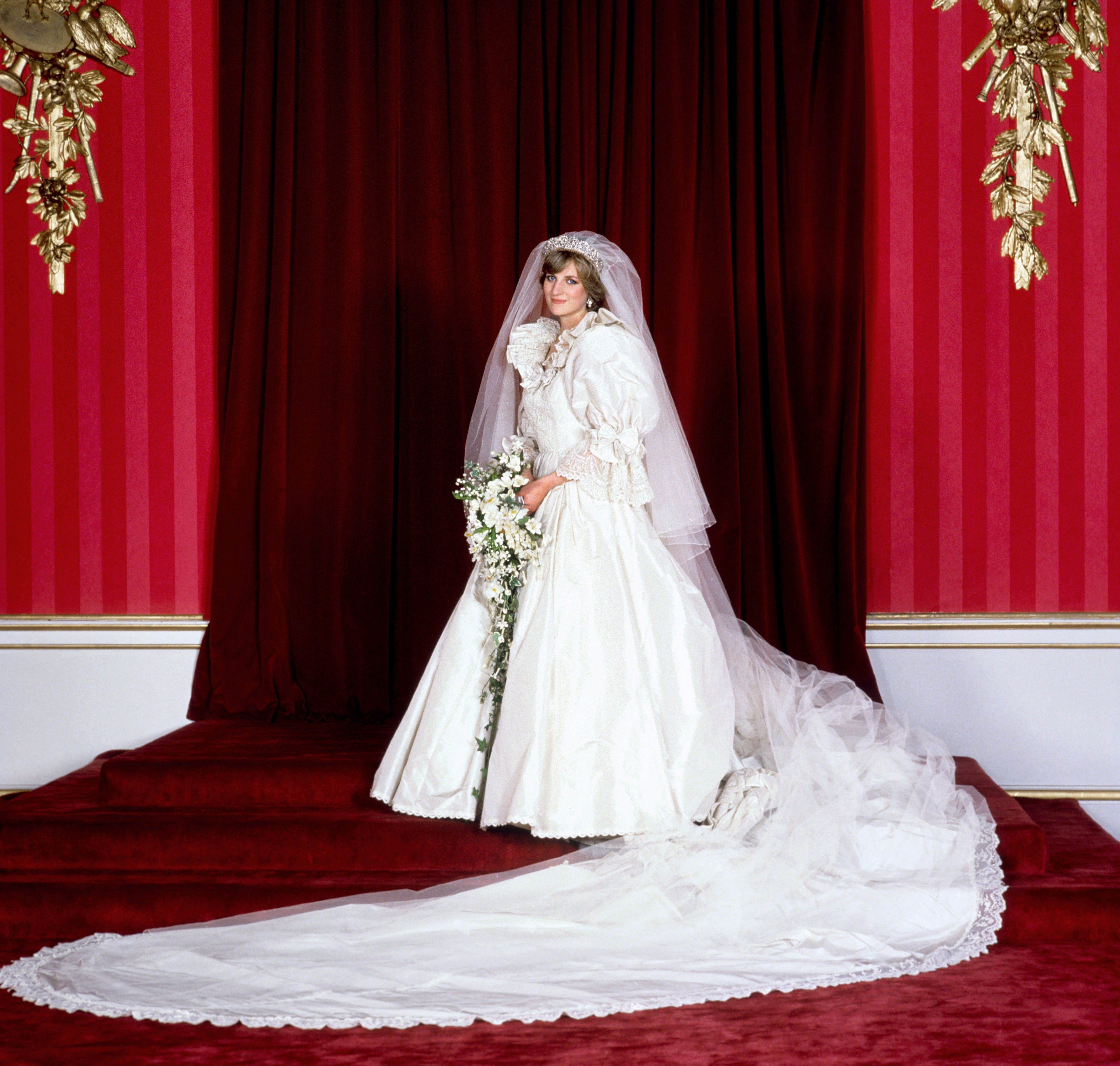 The Princess of Wales in her bridal gown at Buckingham Palace after her marriage to Prince Charles at St. Paul’s Cathedral