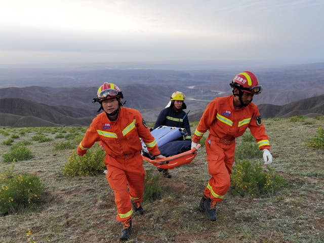 <p>File image: Rescue workers carry a stretcher as they work at the site where extreme cold weather killed participants of an 100-km ultramarathon race in Baiyin, Gansu province, China </p>