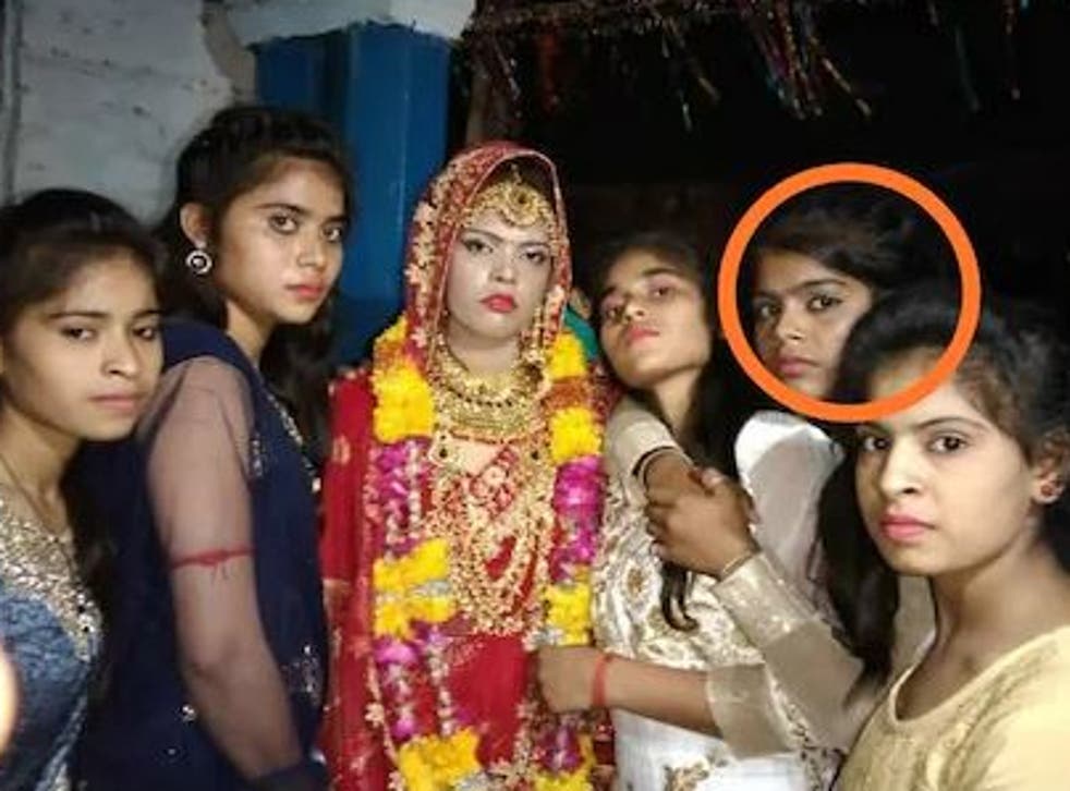 <p>The original bride (centre) alongside her younger sister (circled) who would go on to replace her at the ceremony</p>