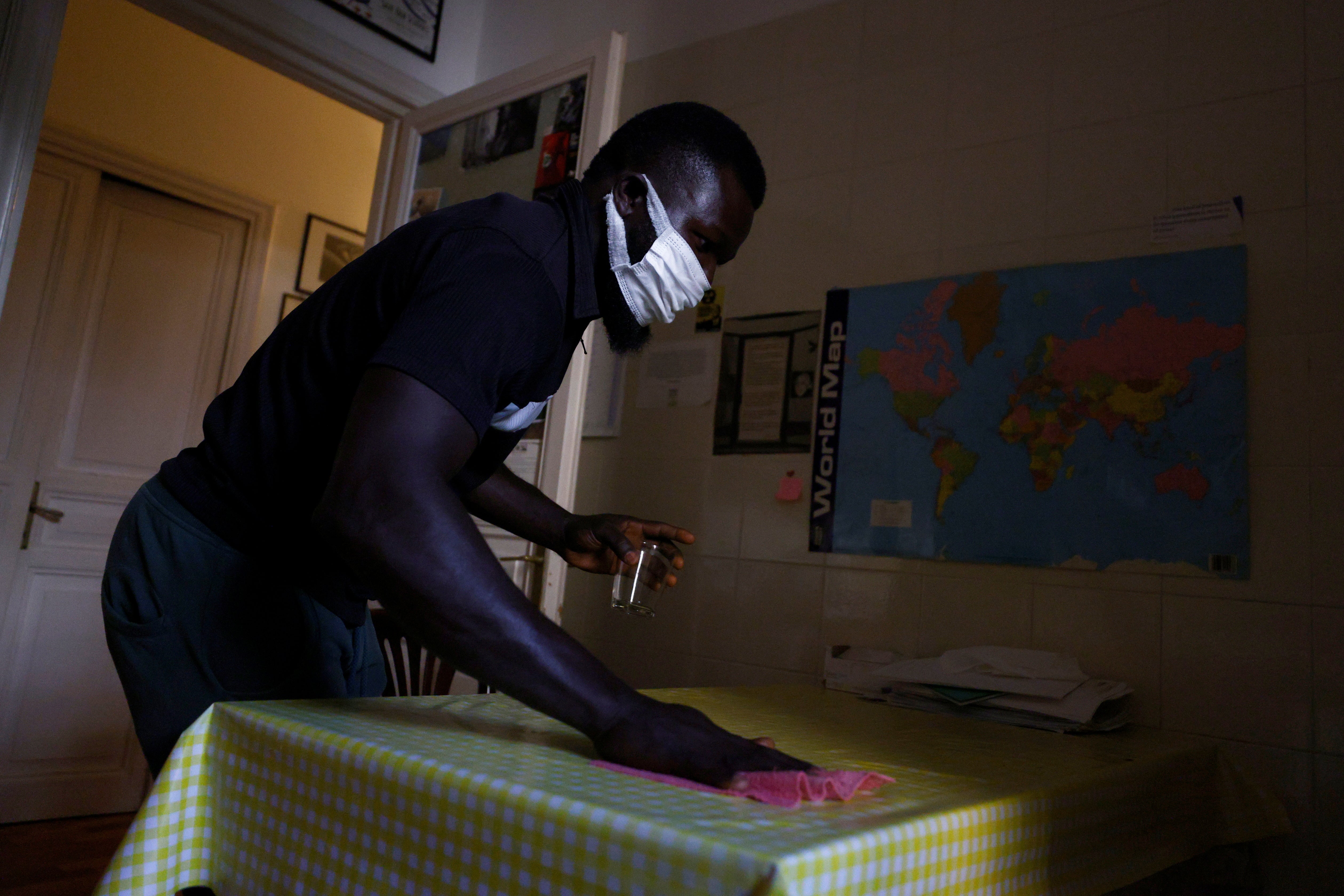Frank Agbontaen, from Nigeria, cleans a kitchen in Rome