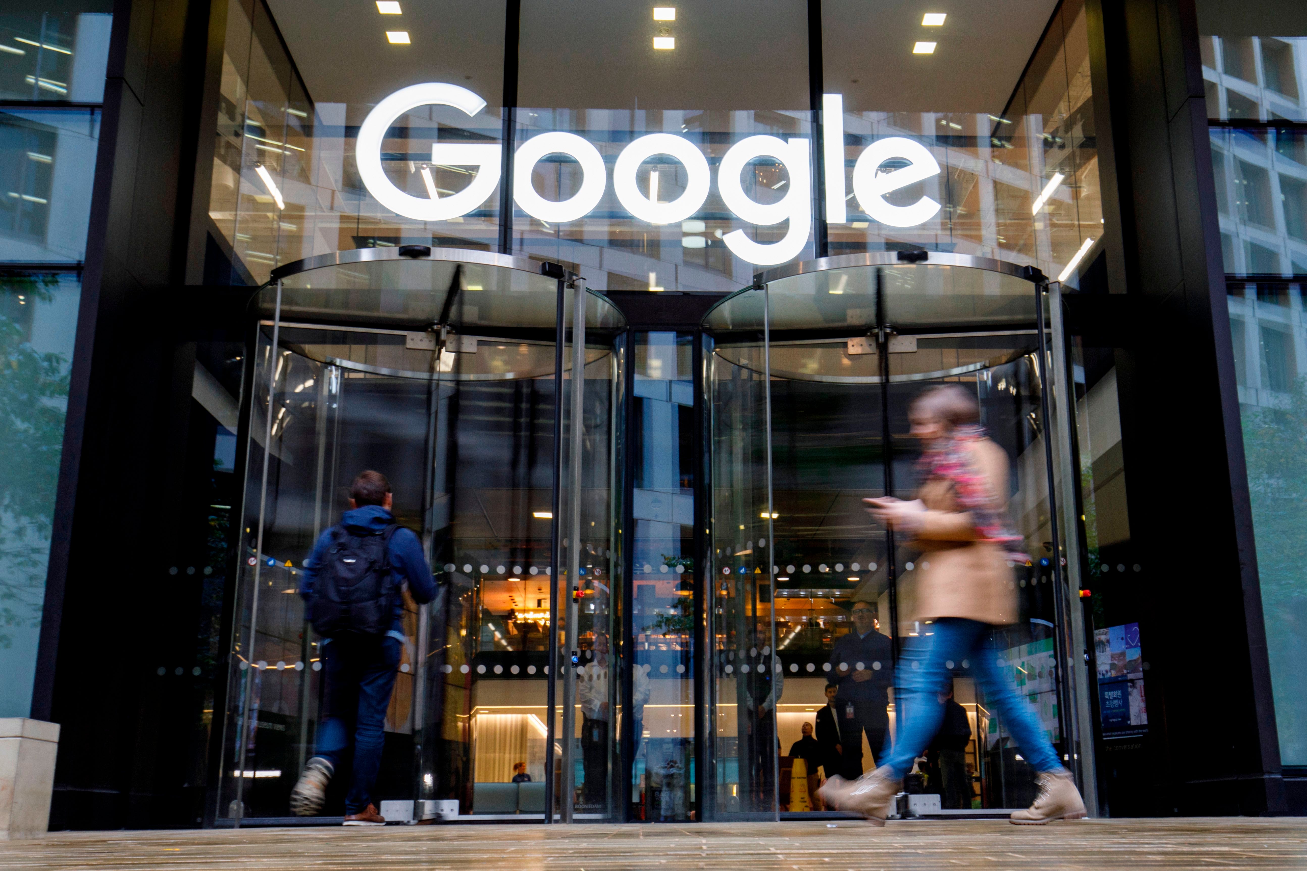 People walk past Google's UK headquarters in London on November 1, 2018.