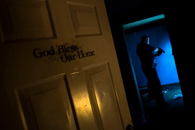 <p>Huntington Police searches an abandoned house littered with needles in Huntington, West Virginia</p>