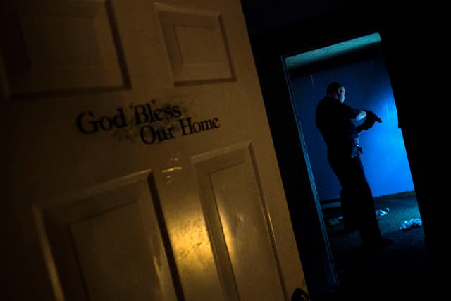 <p>Huntington Police searches an abandoned house littered with needles in Huntington, West Virginia</p>