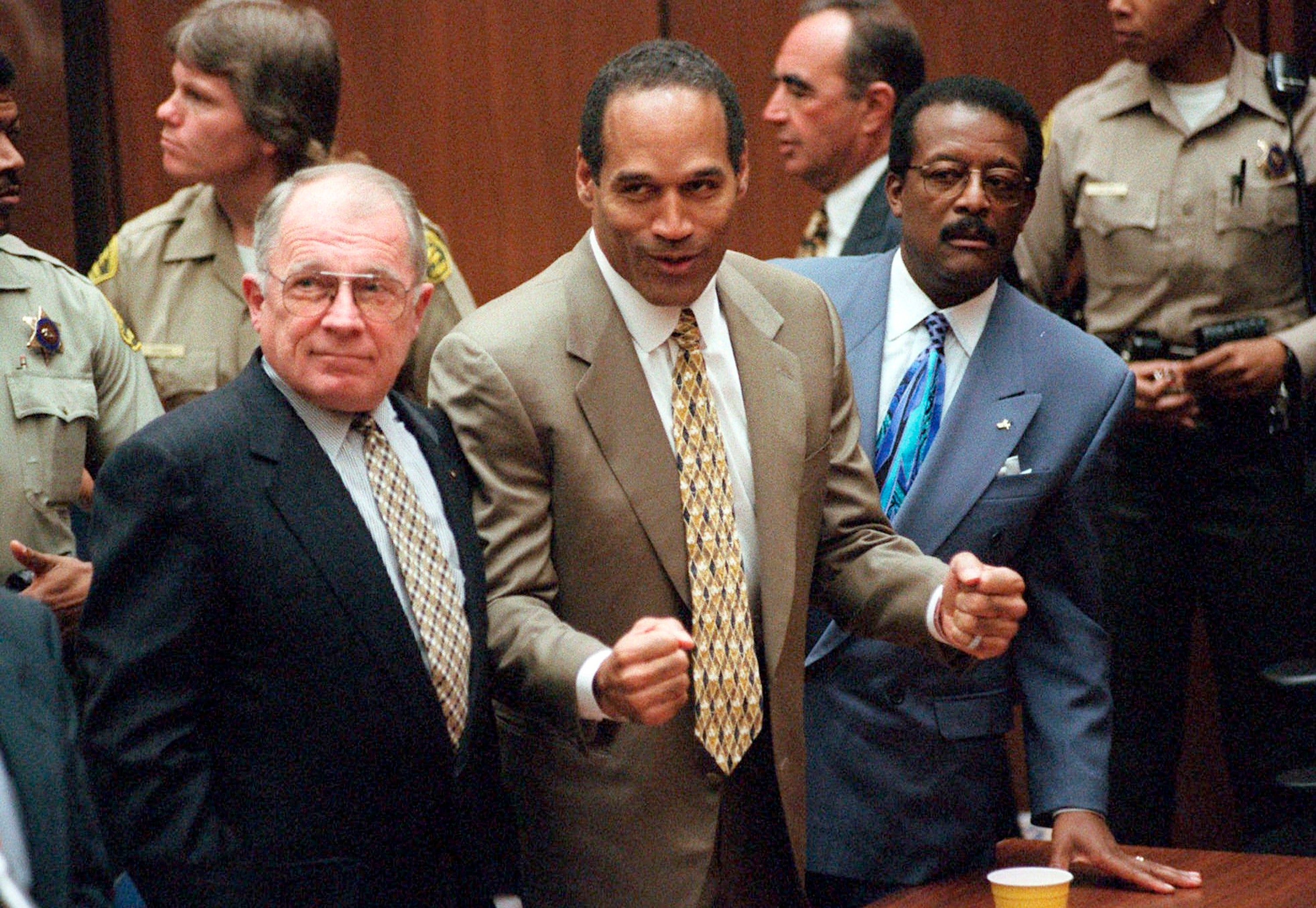 <p>FILE - In this Oct. 3, 1995, file photo, O.J. Simpson reacts as he is found not guilty in the death of his ex-wife Nicole Brown Simpson and her friend Ron Goldman in Los Angeles. Defense attorneys F. Lee Bailey, left, and Johnnie L. Cochran Jr. stand with him. Cochran, Simpson's flamboyant lead attorney, died of brain cancer in 2005 at 68. His refrain to jurors that "If it doesn't fit, you must acquit" sought to underscore that the bloody gloves found at Simpson’s home and the crime scene were too small for football legend when he tried them on in court. (Myung J. Chun/Los Angeles Daily News via AP, Pool, File)</p>