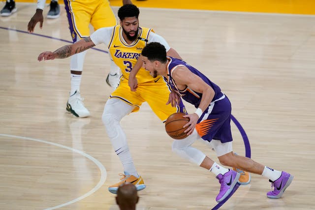 Los Angeles Lakers forward Anthony Davis defends against Phoenix Suns guard Devin Booker
