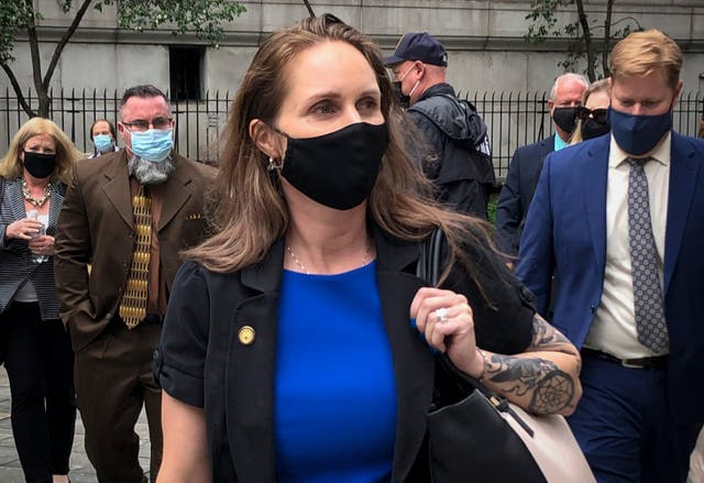 <p>Natalie Mayflower Sours Edwards, centre, leaves court after receiving a six-month prison sentence for leaking confidential financial reports to a journalist at Buzzfeed</p>