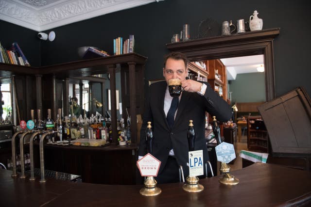 A man drinking in a pub