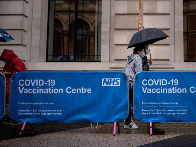 <p>Members of the public arrive at a Covid-19 vaccination centre at London’s Science Museum on Friday</p>