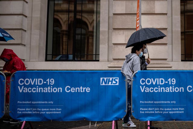 <p>Members of the public arrive at a Covid-19 vaccination centre at London’s Science Museum on Friday</p>