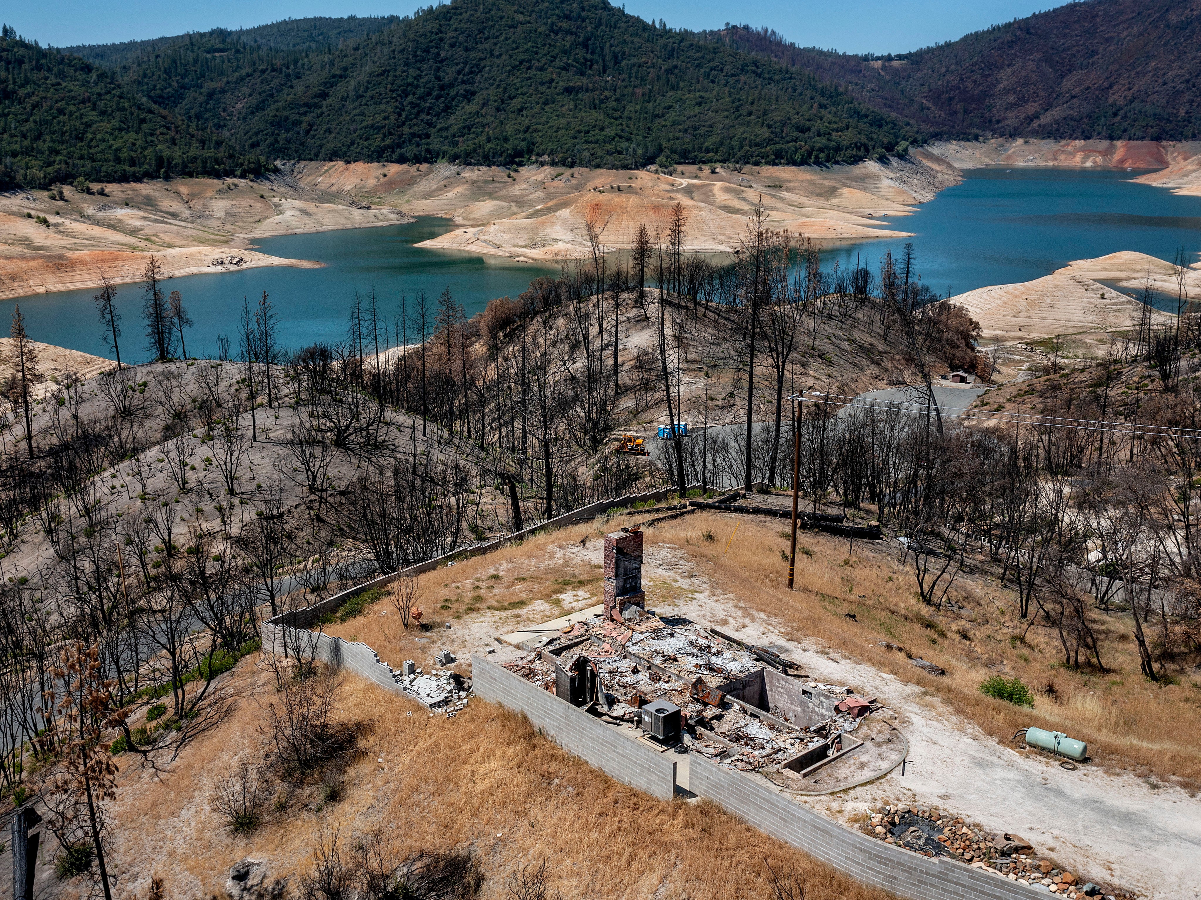 A home destroyed in the 2020 North Complex Fire sits above Lake Oroville on Sunday 23 May 2021, in Oroville, California