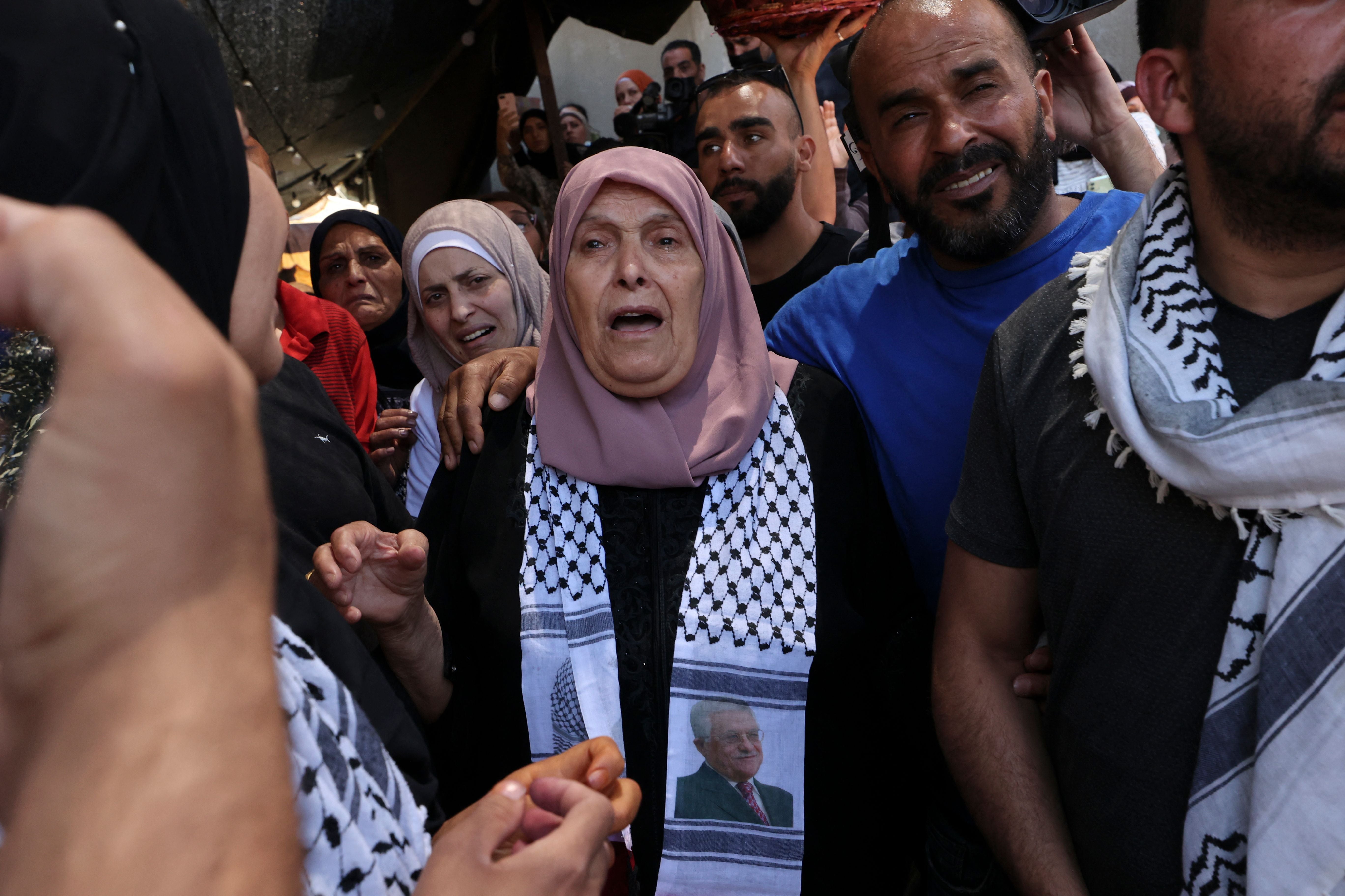 Relatives of Palestinian Birzeit University student Fadi Wahha, who was reportedly shot by Israeli security forces during a protest, mourn at his burial in Birzeit on 3 June