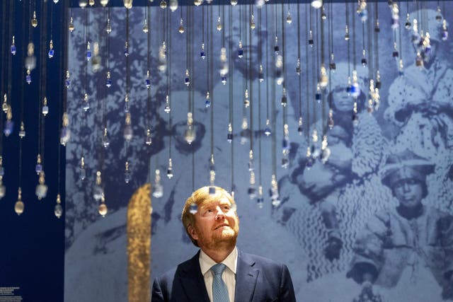 <p>King Willem-Alexander looks on during the opening of the Slavery exhibition at the Rijksmuseum in Amsterdam on 18 May</p>
