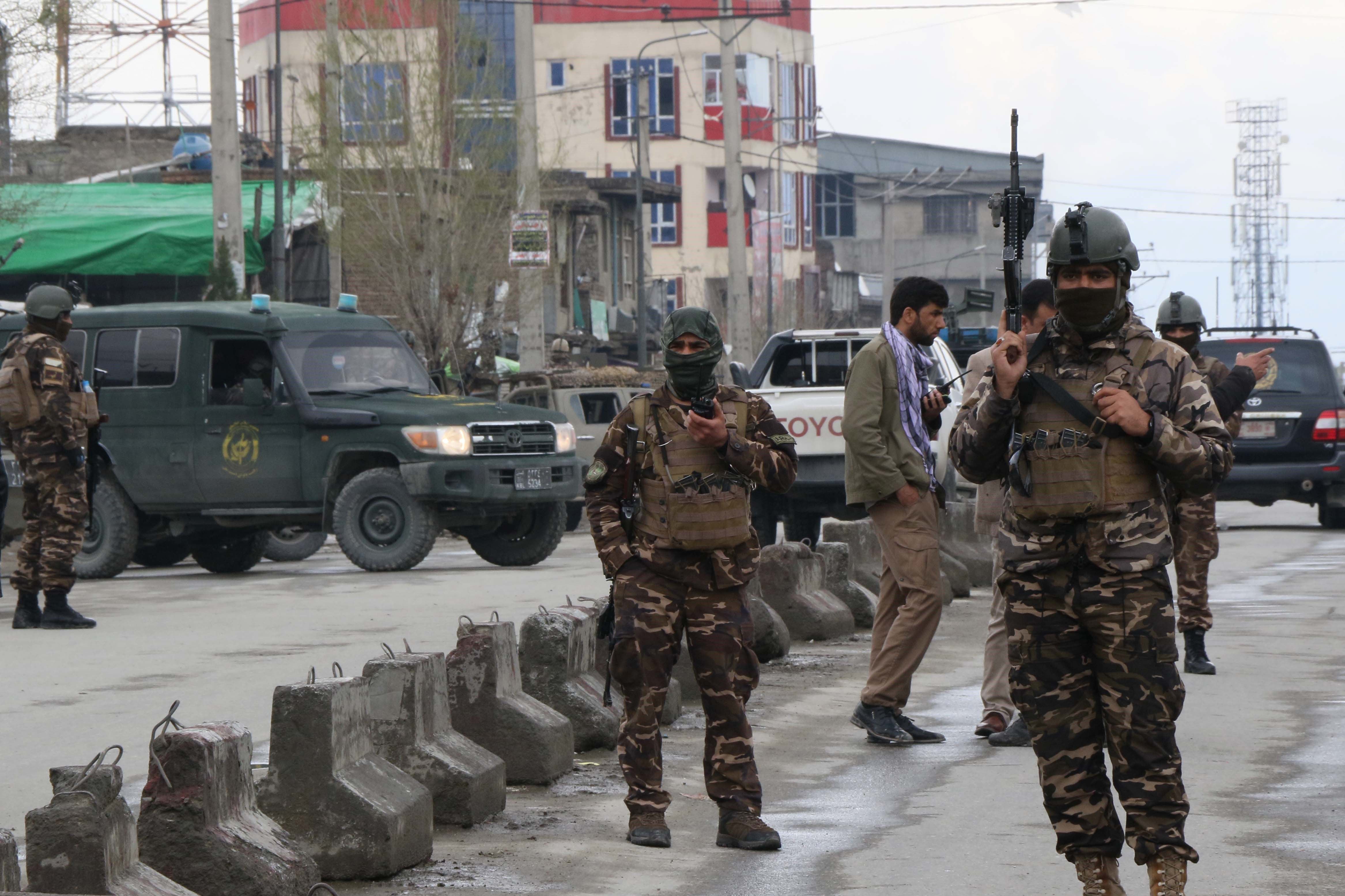 Afghan security personnel stand guard near the site of an Isis attack on a Sikh temple in Kabul in 2020