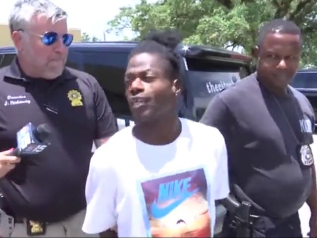 <p>Jeffrey McCants Jr is interviewed as he is being led to a police cruiser after allegedly stealing a fire service vehicle</p>