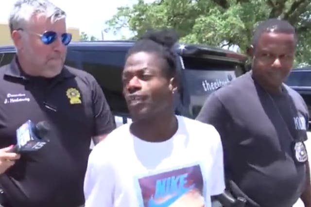 <p>Jeffrey McCants Jr is interviewed as he is being led to a police cruiser after allegedly stealing a fire service vehicle</p>