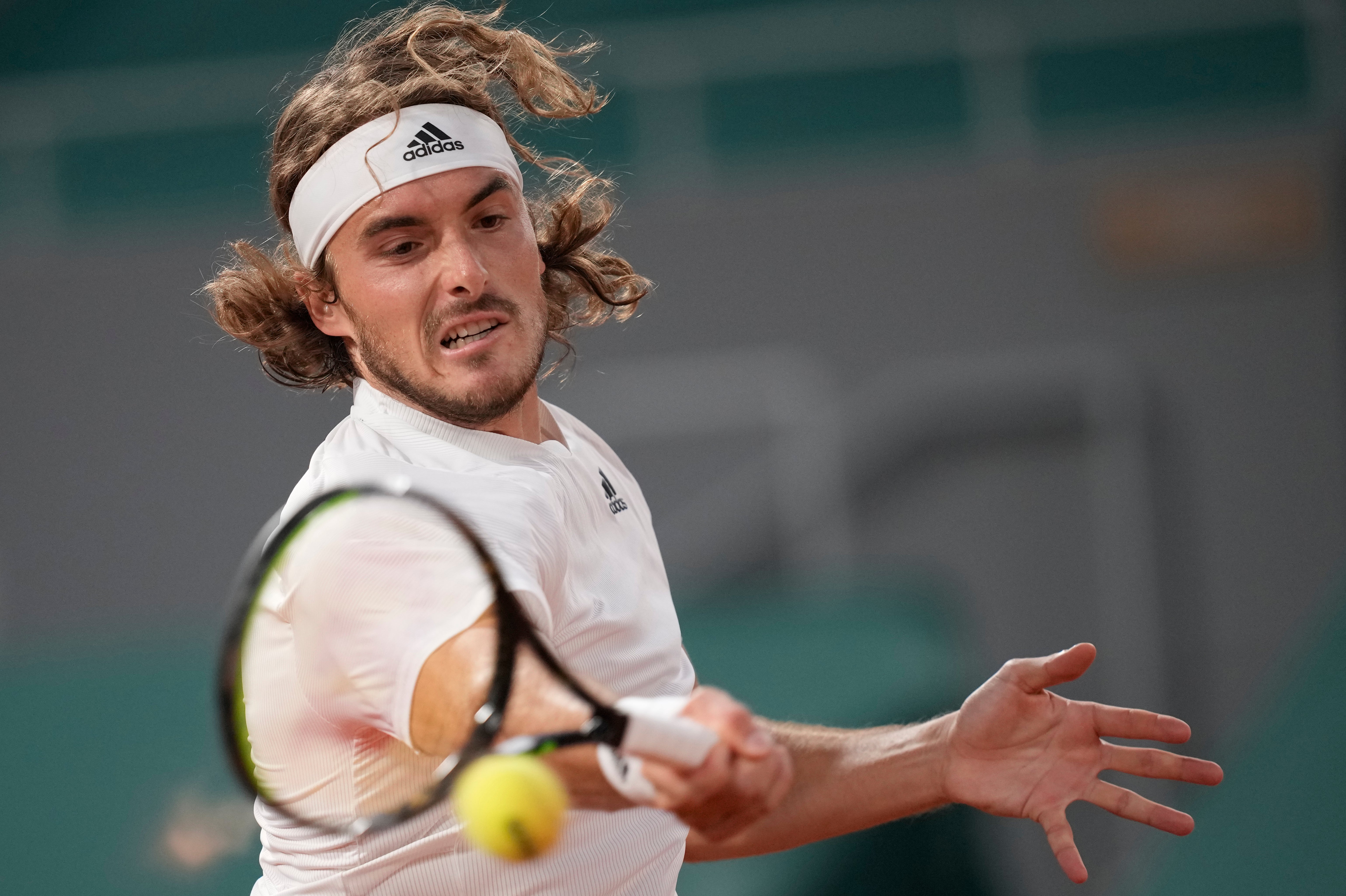 Stefanos Tsitsipas hits a forehand during his victory over John Isner