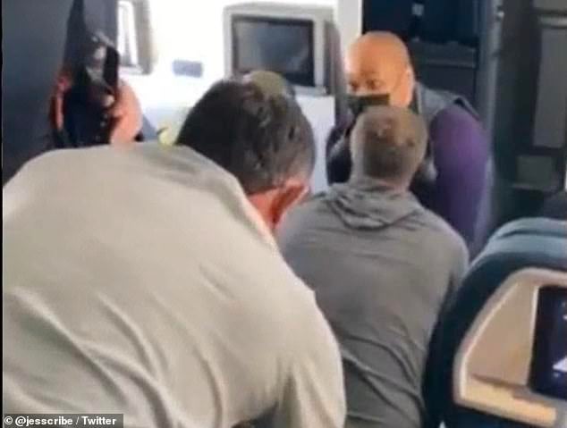 A video posted on Twitter by a passenger on a flight to Nashville shows attendants and passengers holding down a man who reportedly attempted to break into the cockpit