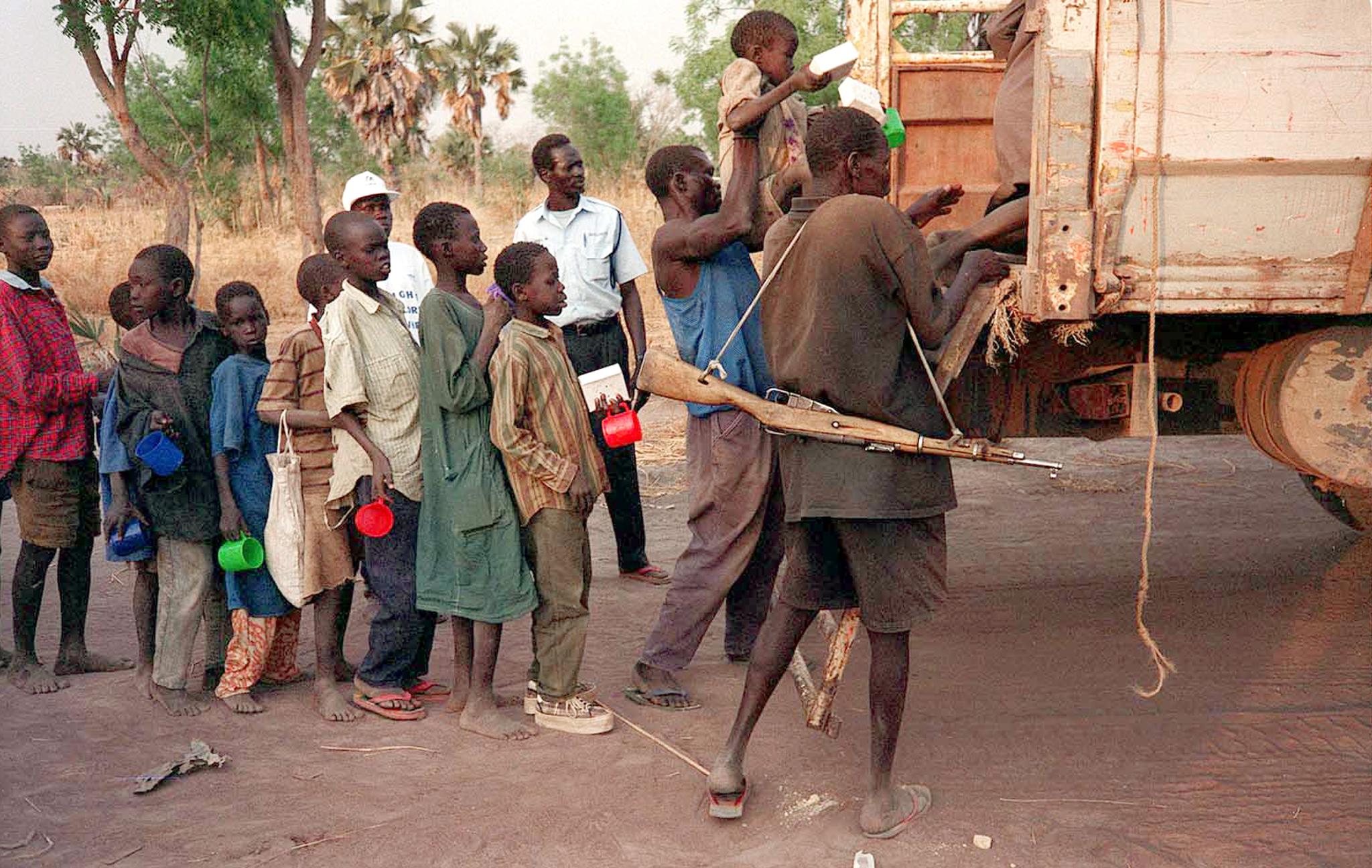 Former rebel child soldiers board a lorry to take them to a Unicef-funded rehabilitation centre after they were demobilised from the military in Sudan’s Bahr el-Ghazal region in 2001