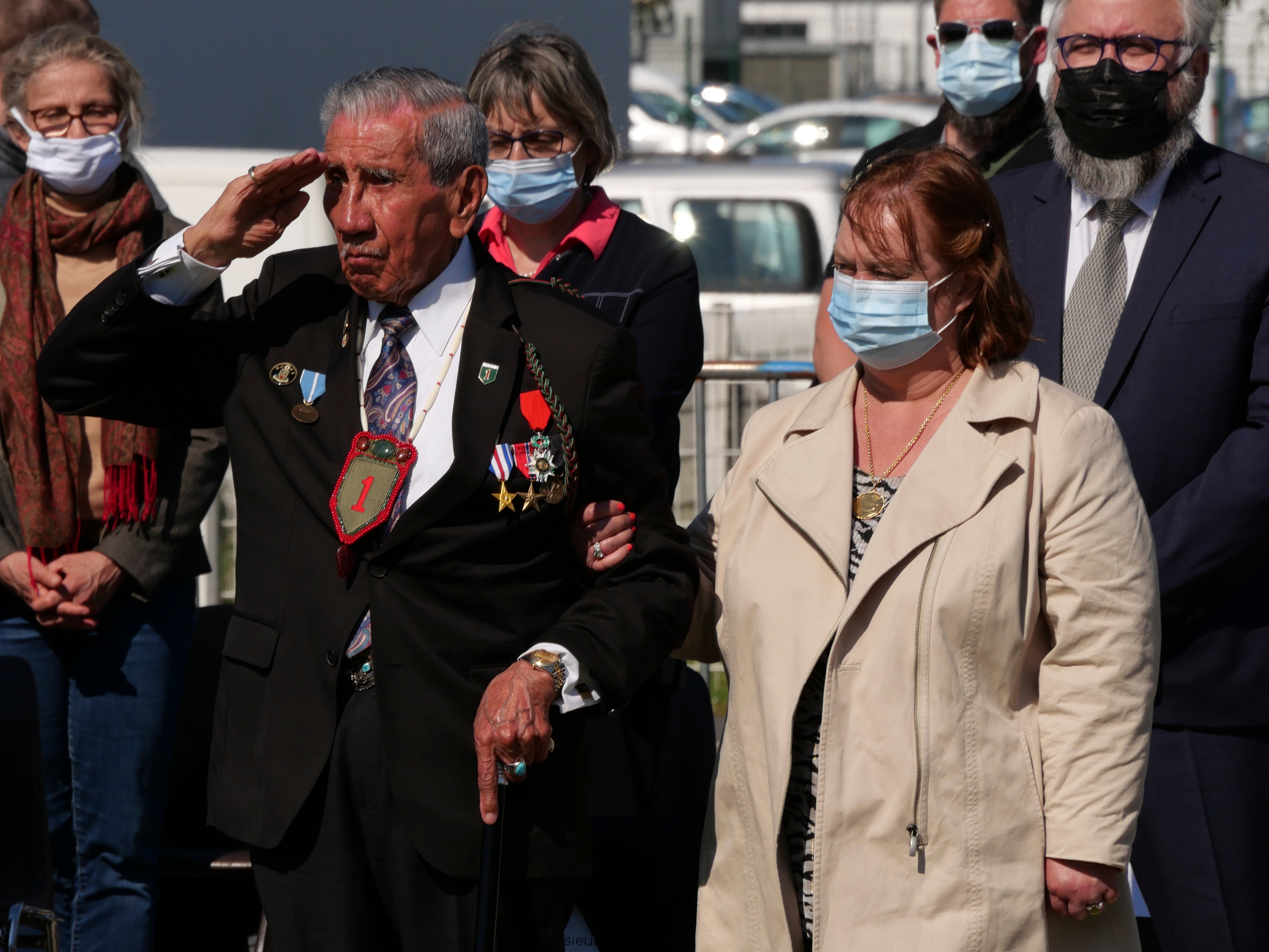 Charles Shay, a 96-year-old native American from Maine, salutes during a D-Day ceremony in Carentan, Normandy