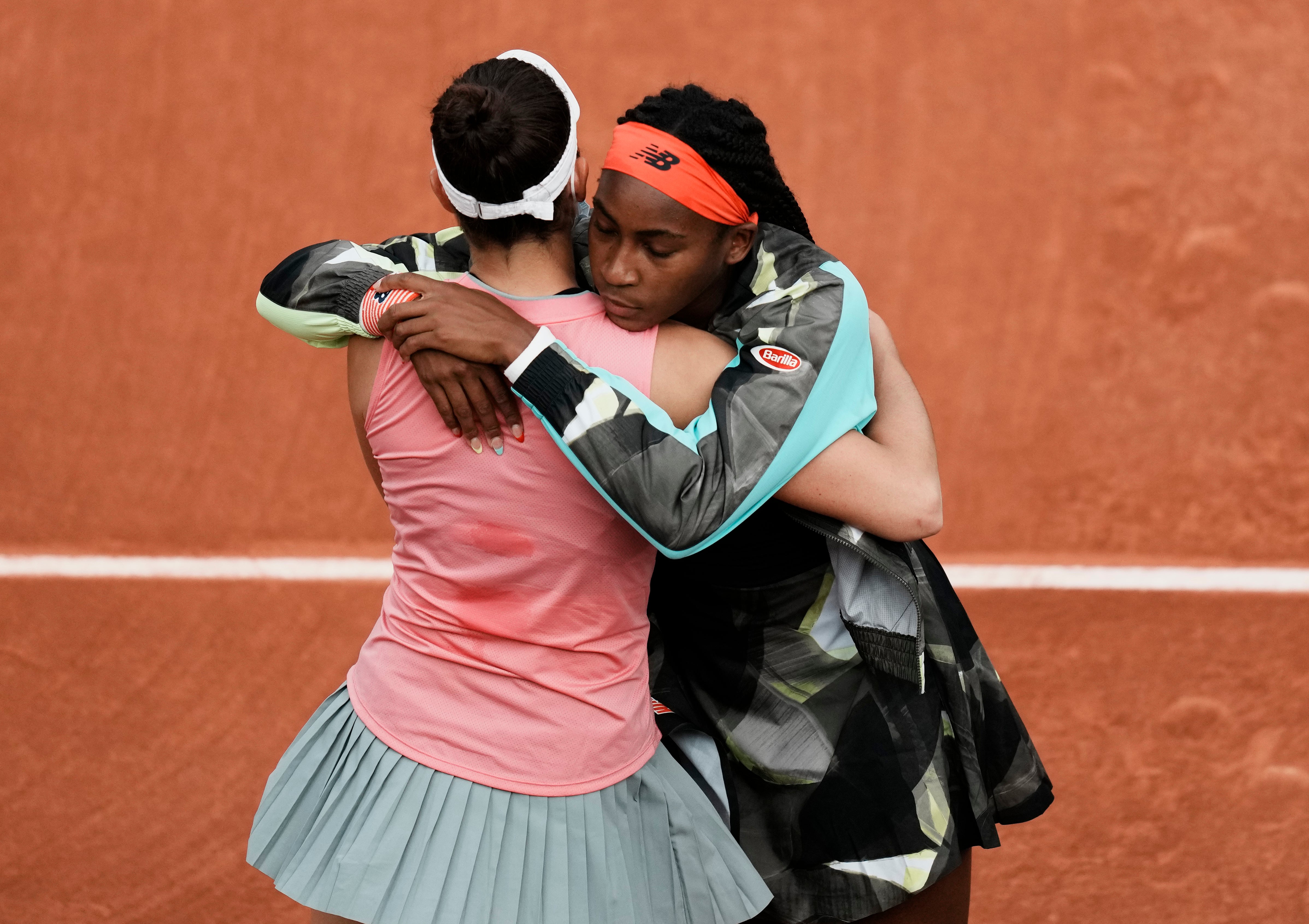 Coco Gauff, right, hugs Jennifer Brady following the latter's retirement