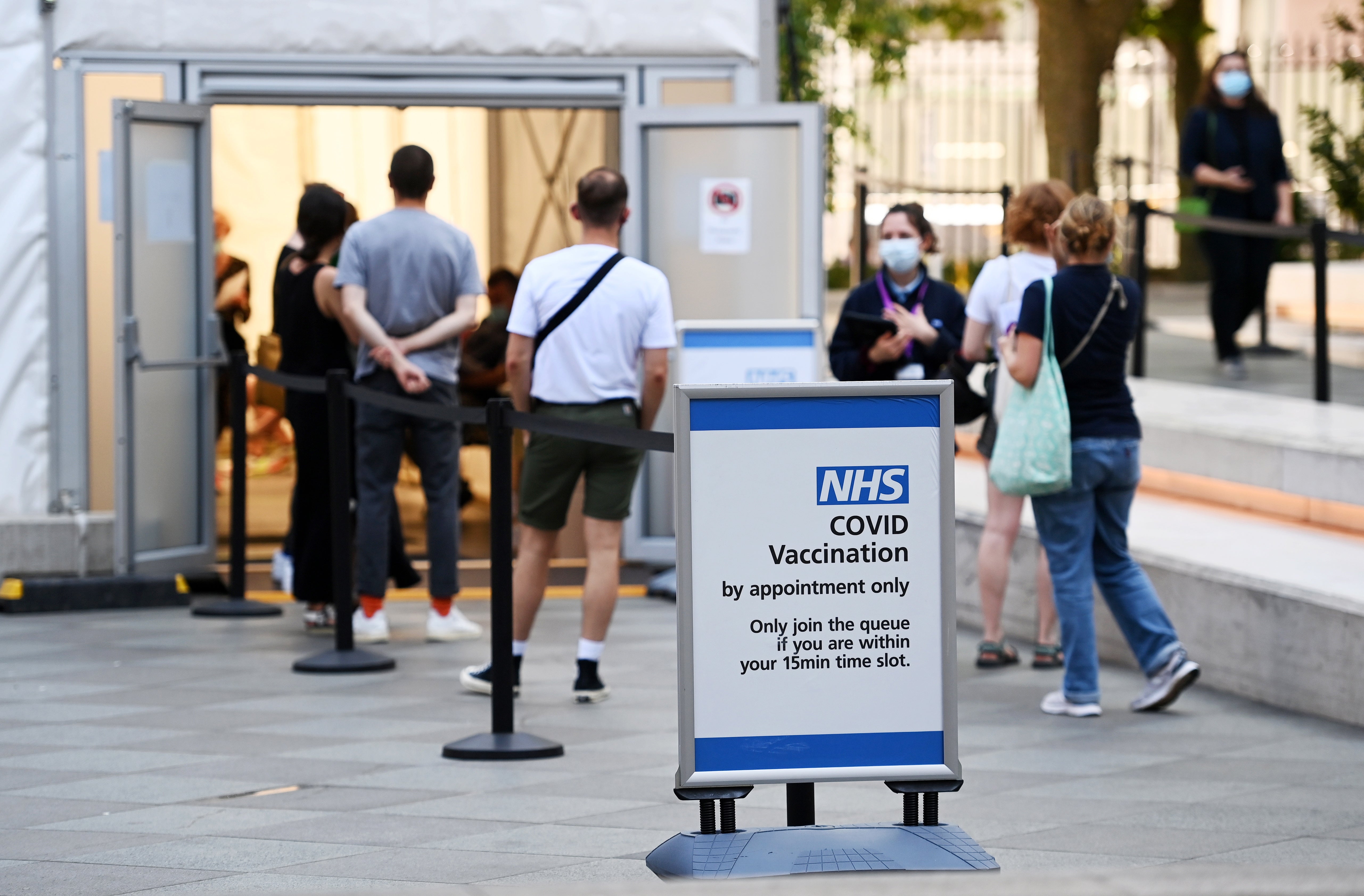 People enter a Covid-19 vaccination centre in London