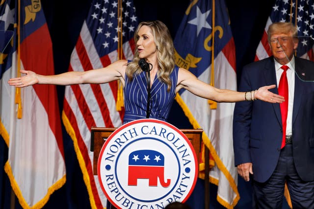 <p>Lara Trump addresses the audience as her father-in-law, former U.S. President Donald Trump, looks on at the North Carolina GOP convention dinner in Greenville, North Carolina</p>
