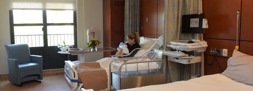 A woman pictured with her newborn in one of Santa Barbara Cottage Hospital’s birthing suites, in a photo released on their website