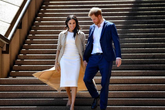 <p>In this file photo taken on October 16, 2018 Britain’s Prince Harry and his wife Meghan walk down the stairs of the iconic Opera House in Sydney.</p>