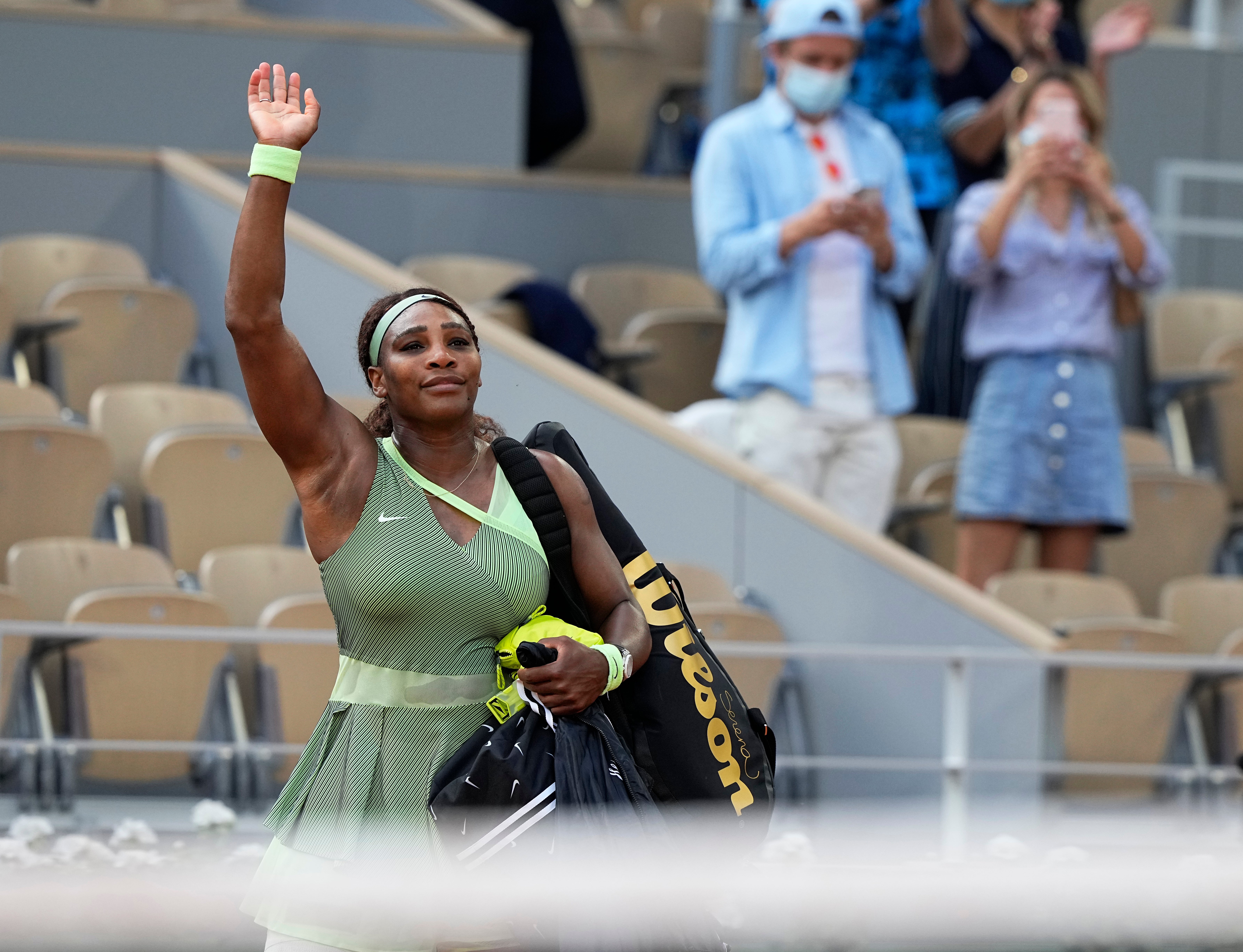 Serena Williams waves to the crowd following her loss to Elena Rybakina