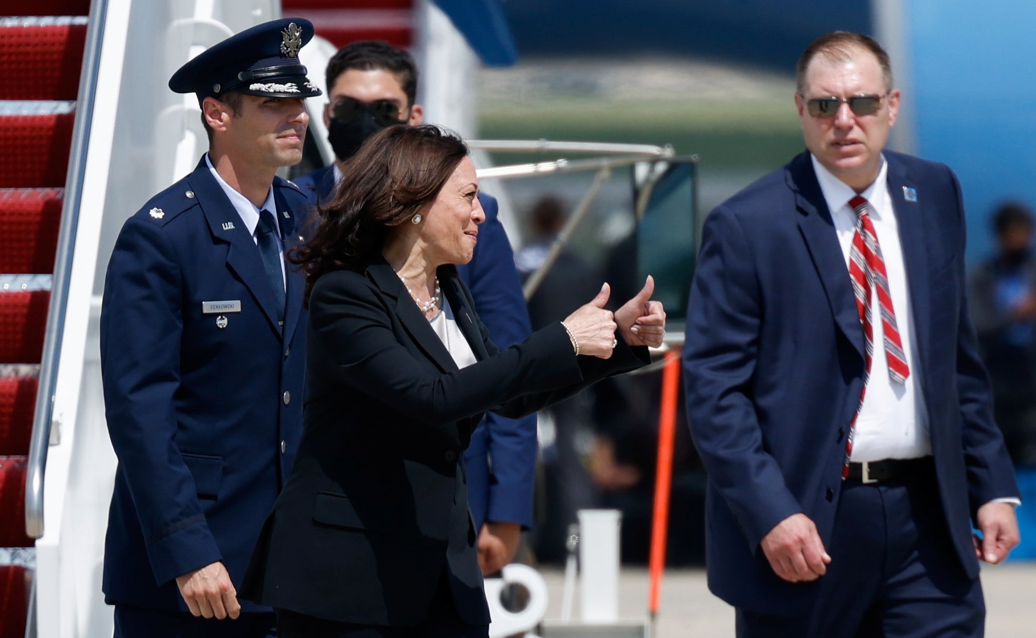 Kamala Harris gives a thumbs-up after her plane was forced to land shortly after take-off