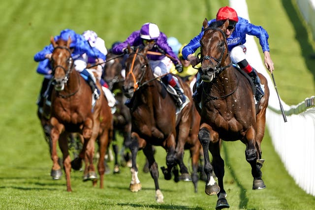 Mojo Star (purple, centre) in action at Epsom